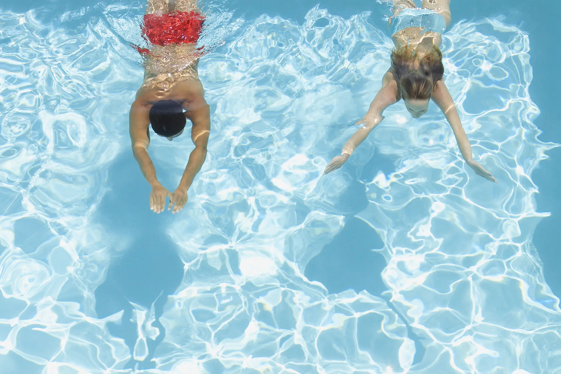 Couple swimming in a fiberglass pool
